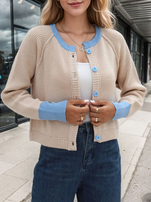 Raglan sleeve knit cardigan in tan with blue trim and buttons.