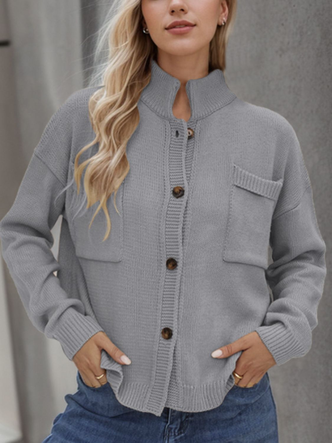Gray acrylic knit cardigan with stand collar, button front, and two chest pockets.