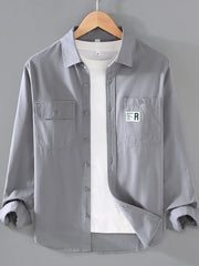 Light Gray cotton long-sleeve overshirt with buttoned chest pockets and a white t-shirt underneath.