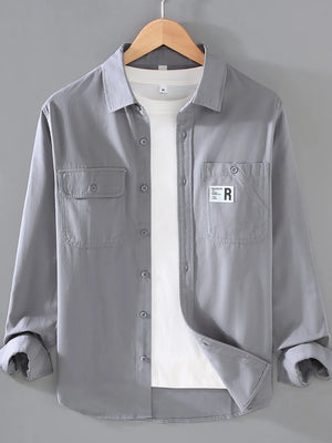Light Gray cotton long-sleeve overshirt with buttoned chest pockets and a white t-shirt underneath.