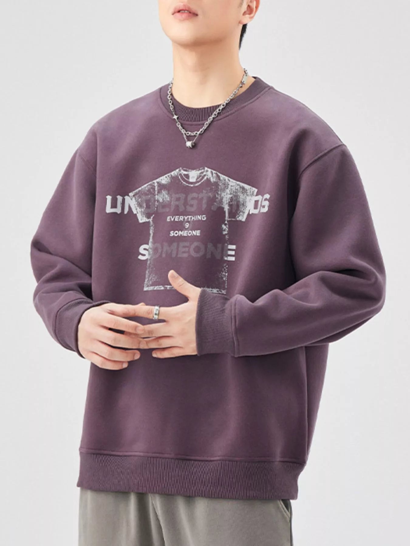Men's oversized purple graphic sweatshirt with crewneck and long sleeves.