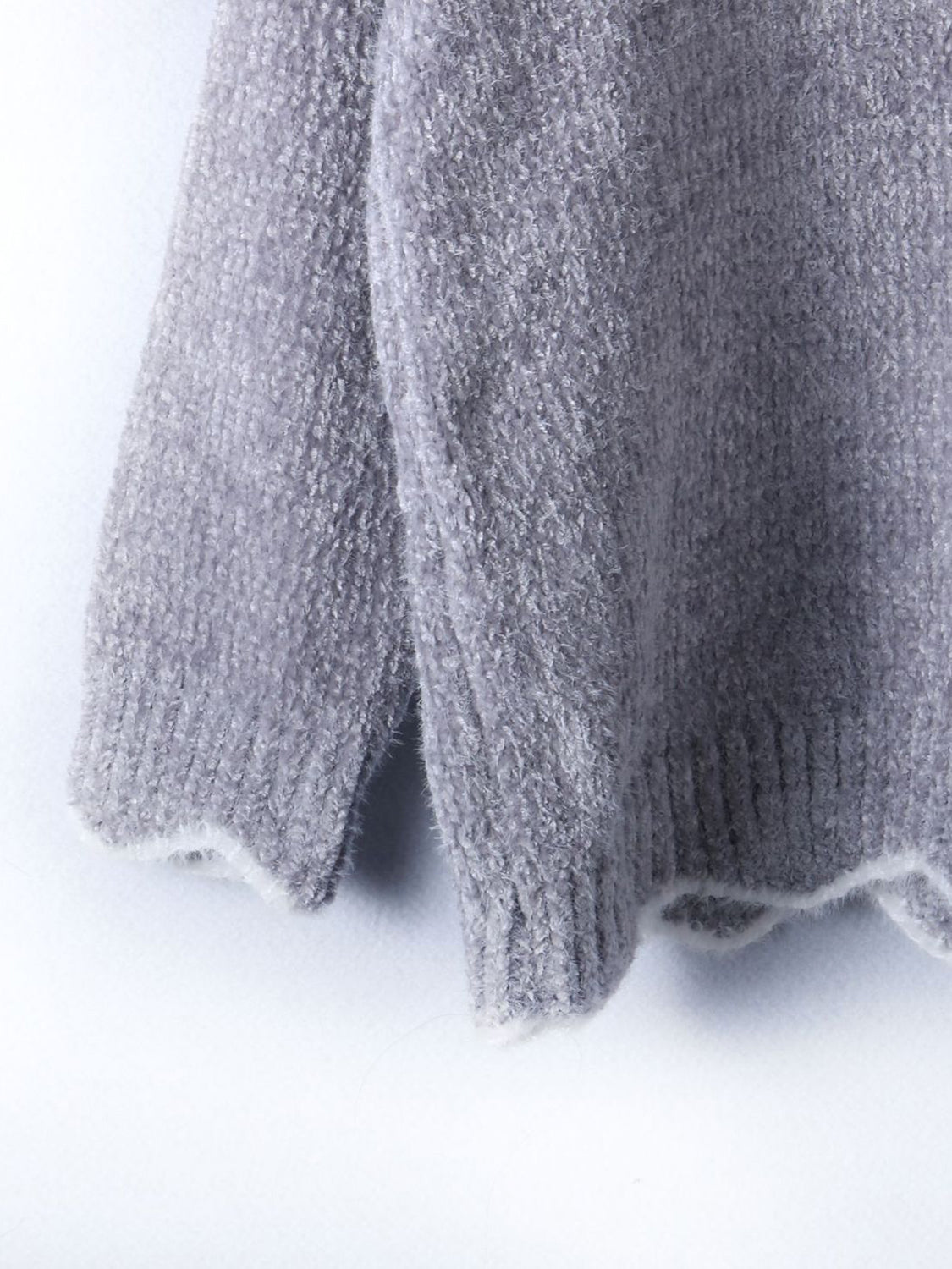Gray acrylic knit sweater with scalloped trim detail on hem and cuffs.