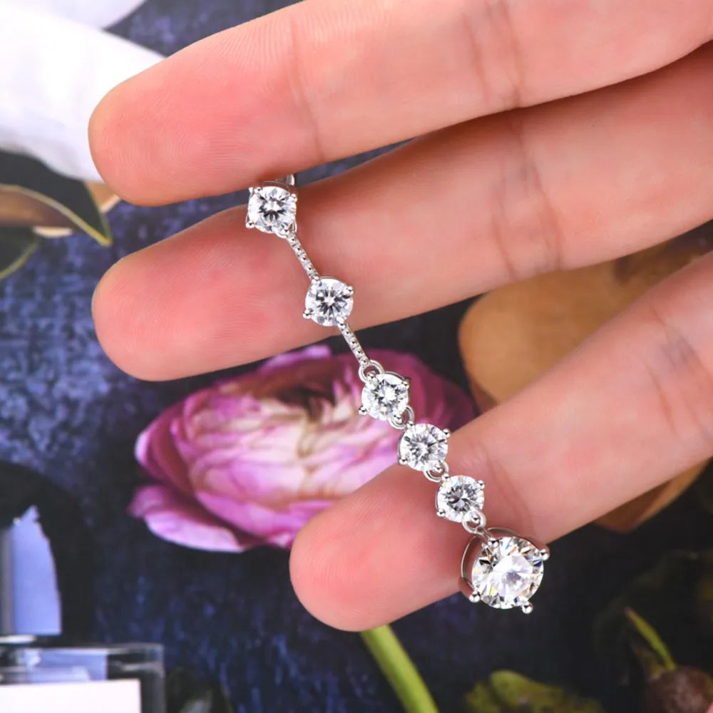 Silver cascading drop earrings with multiple brilliant-cut diamonds.