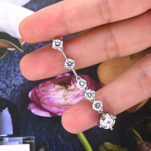 Silver cascading drop earrings with multiple brilliant-cut diamonds.