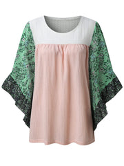 Textured panel blouse in blush pink with white waffle knit and green floral flutter sleeves.