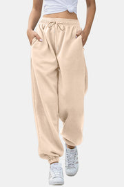 Relaxed-fit cuffed sweatpants in tan with drawstring waist and pockets.