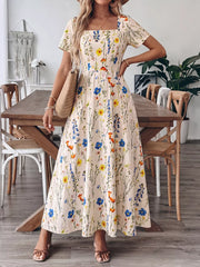 Wildflower A-line maxi dress with square neckline and short sleeves, featuring a floral print.
