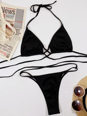 Black ribbed halter bikini set with crisscross detail and string tie bottoms.