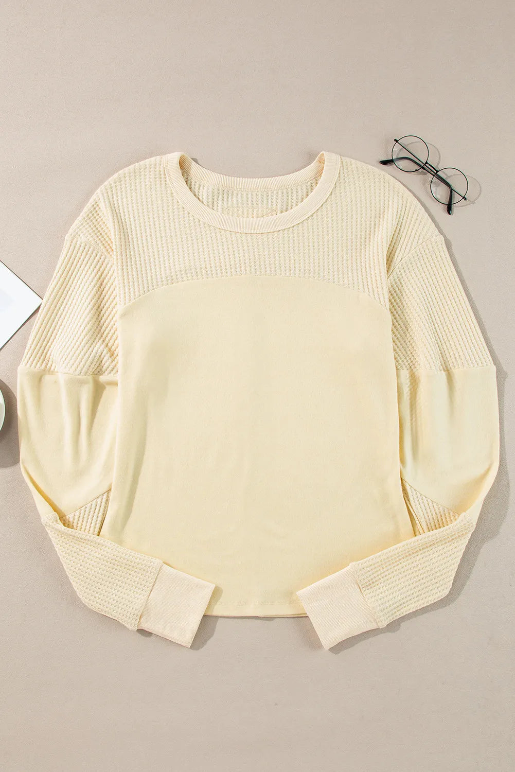 Beige waffle knit colorblock sweatshirt with crewneck and long sleeves.