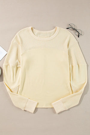 Beige waffle knit colorblock sweatshirt with crewneck and long sleeves.