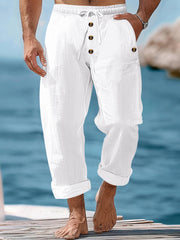 White cotton drawstring sweatpants with button-fly and relaxed fit.