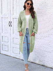 Light green ribbed knit maxi cardigan with pockets and long sleeves.