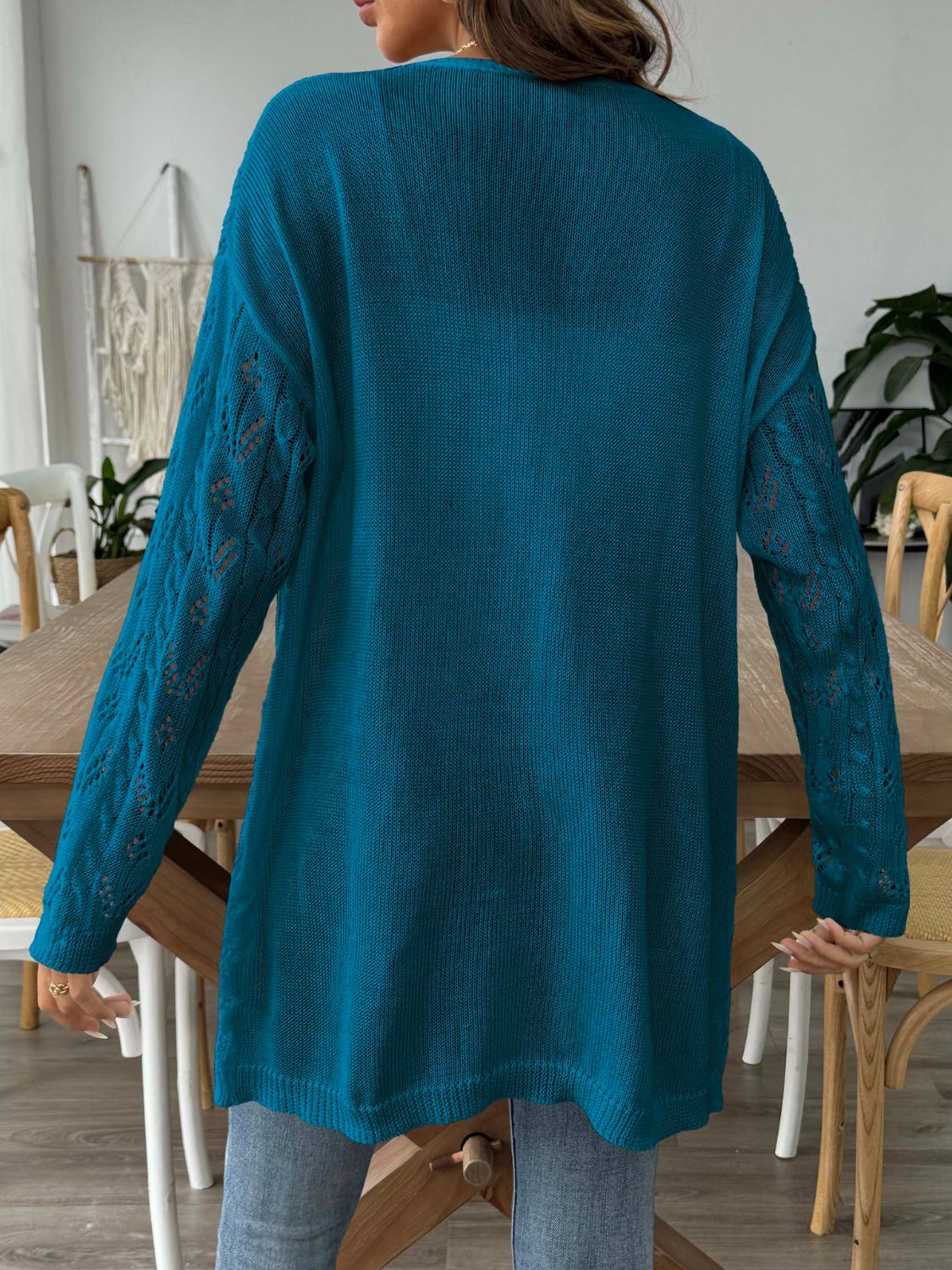 Peacock blue duster cardigan with openwork diamond knit sleeves and a longline cut.