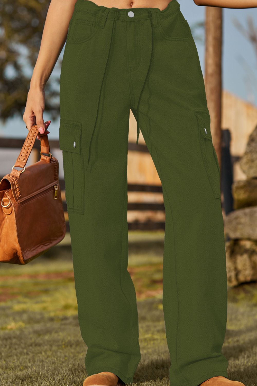 Army green denim drawstring cargo pants with utility pockets and a relaxed fit.