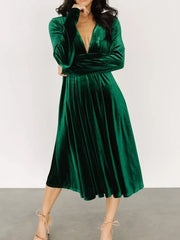 Dark green velvet midi dress with plunging V-neck and long sleeves.