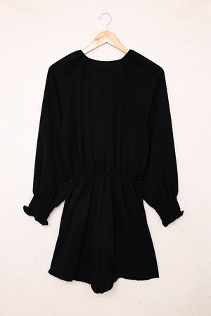 Black tie-front blouson sleeve playsuit with smocked cuffs and waist.