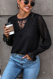 Black lace inset sheer sleeve blouse with V-neck and ruffled cuffs.
