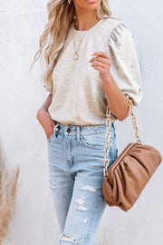 Light gray embellished puff sleeve sweatshirt with pearl details.