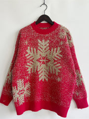 Red acrylic sweater with gold glitter snowflake pattern and crew neck.