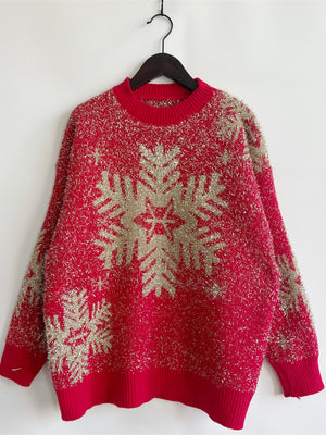 Red acrylic sweater with gold glitter snowflake pattern and crew neck.