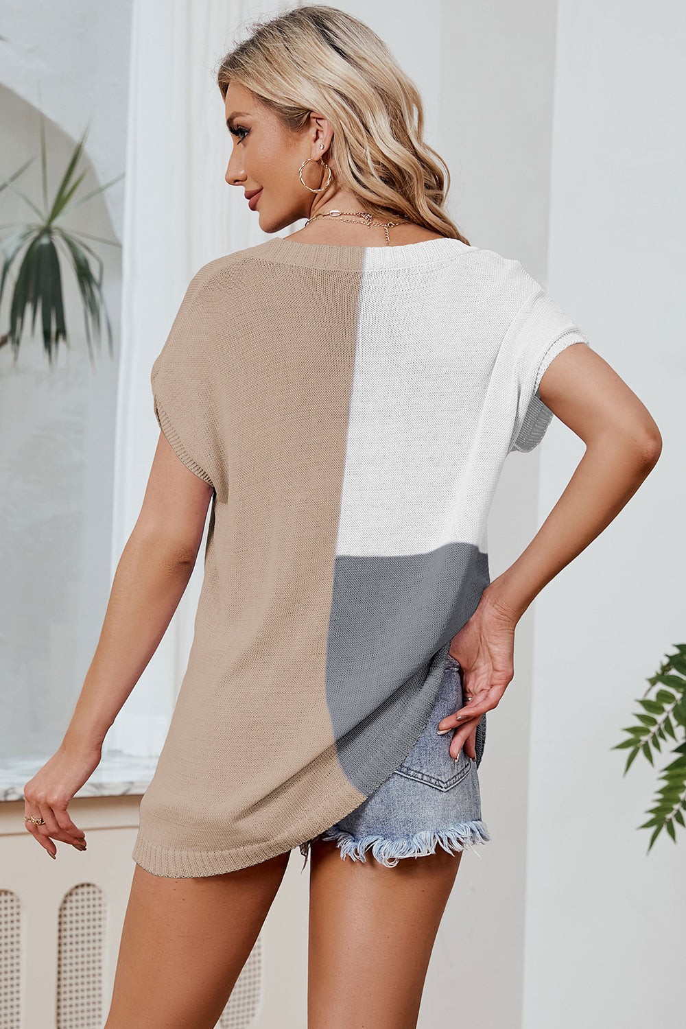 Split-tone knit tee with dolman sleeves in tan, white, and gray, styled with denim shorts.