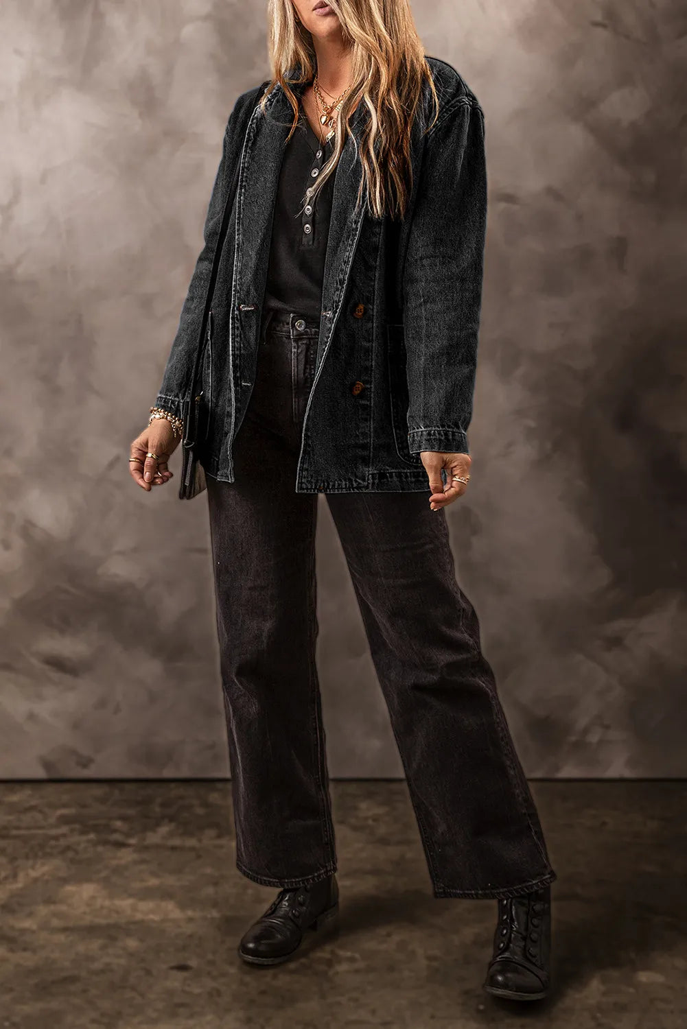 Double-breasted dark wash denim blazer with button closure and notched lapels.