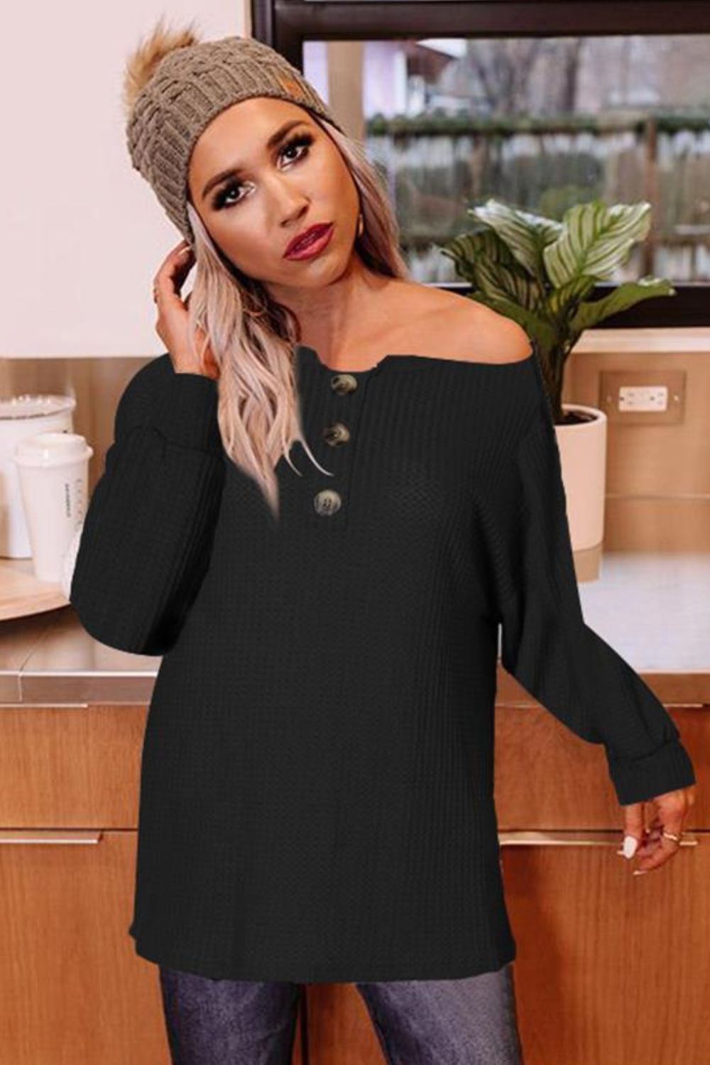 Black waffle knit henley tunic with button detail and boat neck.