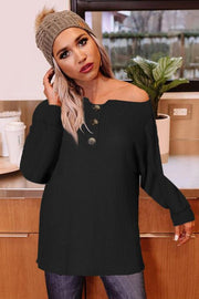Black waffle knit henley tunic with button detail and boat neck.