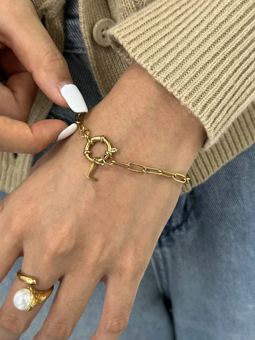 Gold chunky chain bracelet with an L initial charm and toggle clasp