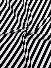 Notched midi dress in black and white stripe fabric with long sleeves.