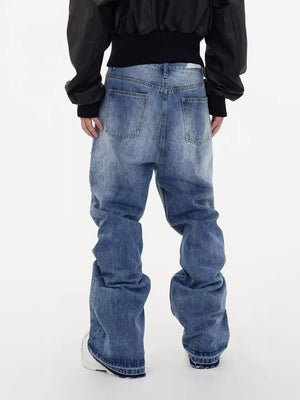 Men's distressed baggy fit jeans in blue denim with a relaxed cut.