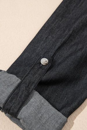 Relaxed black denim shirt with buttoned cuff detail and rolled sleeves.