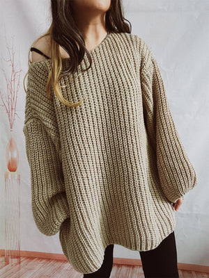 Beige oversized ribbed knit sweater with a V-neck and balloon sleeves.