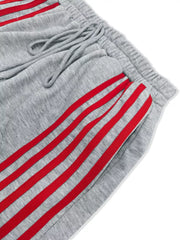 Grey lounge shorts with red side stripes and drawstring waist.