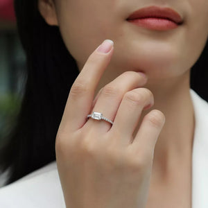 Elegant moissanite geometric silver ring with pave band, 1 carat emerald cut stone.