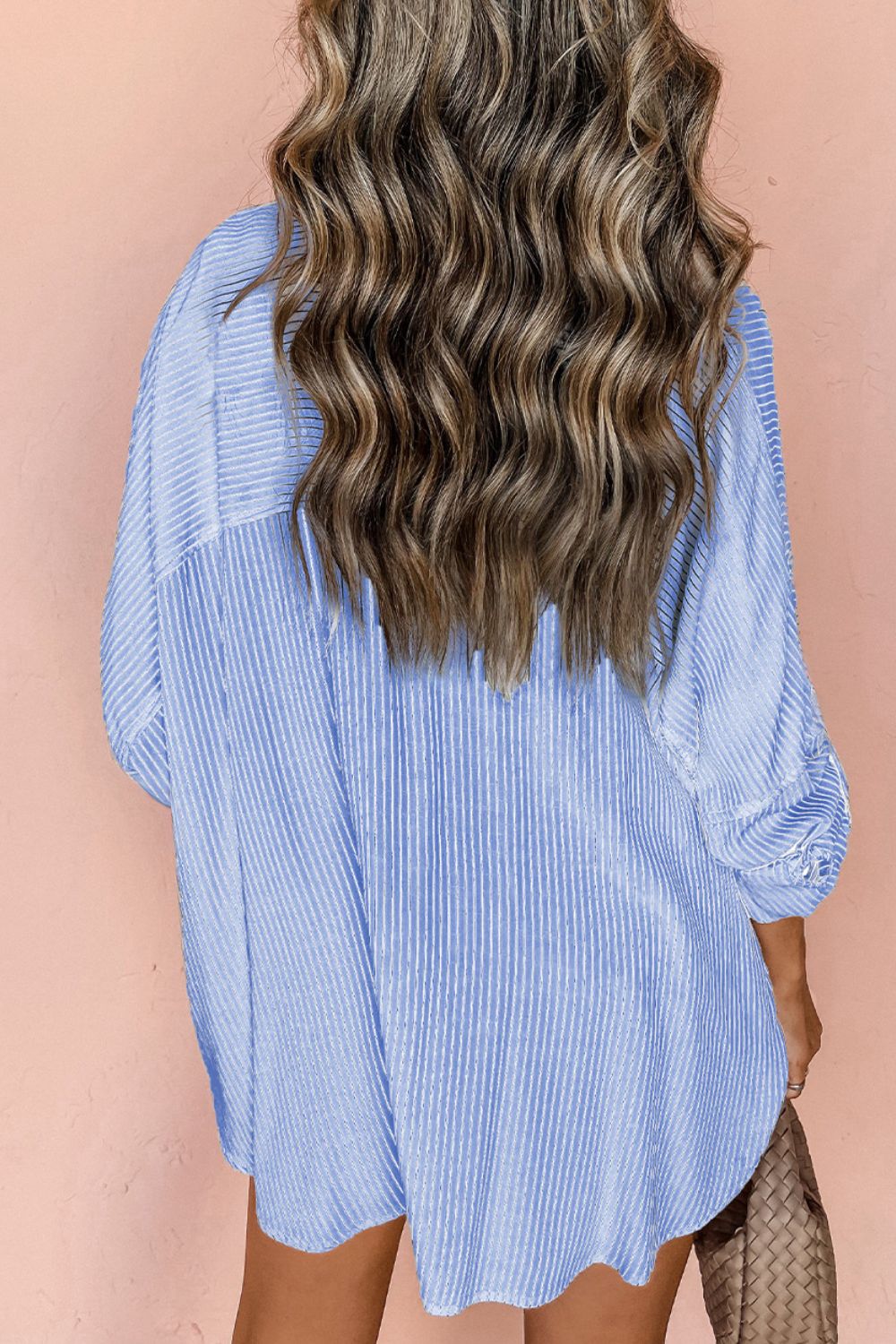 Light blue relaxed fit button-down shirt with vertical stripe texture and subtle pleating.