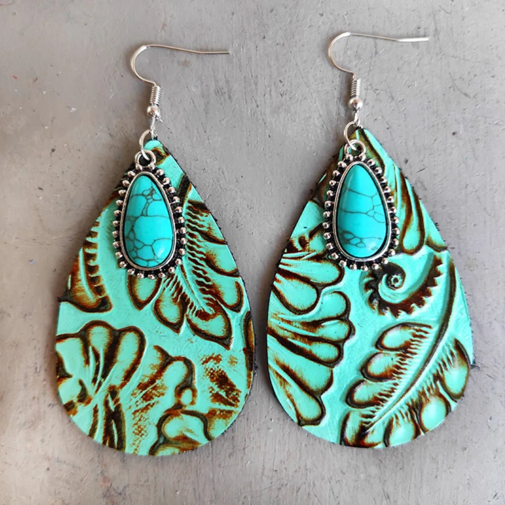 Aqua tooled leather teardrop earrings with turquoise stone detail and silver hooks.