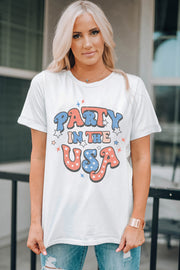 White graphic t-shirt with "Party in the USA" text and stars in red, white, and blue.