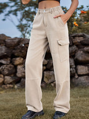 Tan denim cargo pants with elastic waistline and utility pockets.