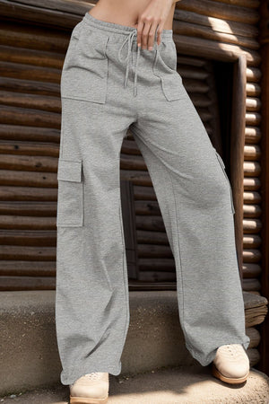 Gray wide-leg cargo lounge trousers with utility pockets and drawstring waist