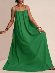 Green crinkled maxi swim dress with spaghetti straps and a flowy silhouette.