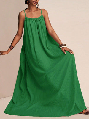 Green crinkled maxi swim dress with spaghetti straps and a flowy silhouette.