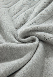Gray lace-effect knit button-down cardigan with a diamond pattern detail.
