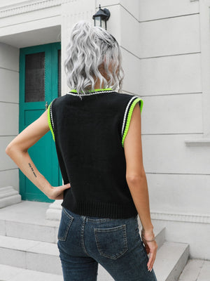 Black argyle knit sweater vest with neon green trim and ribbed hem.