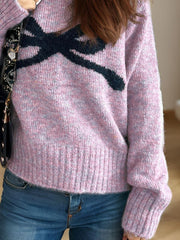 Pink purple intarsia knit sweater with black bow detail, crew neck, ribbed cuffs and hem.