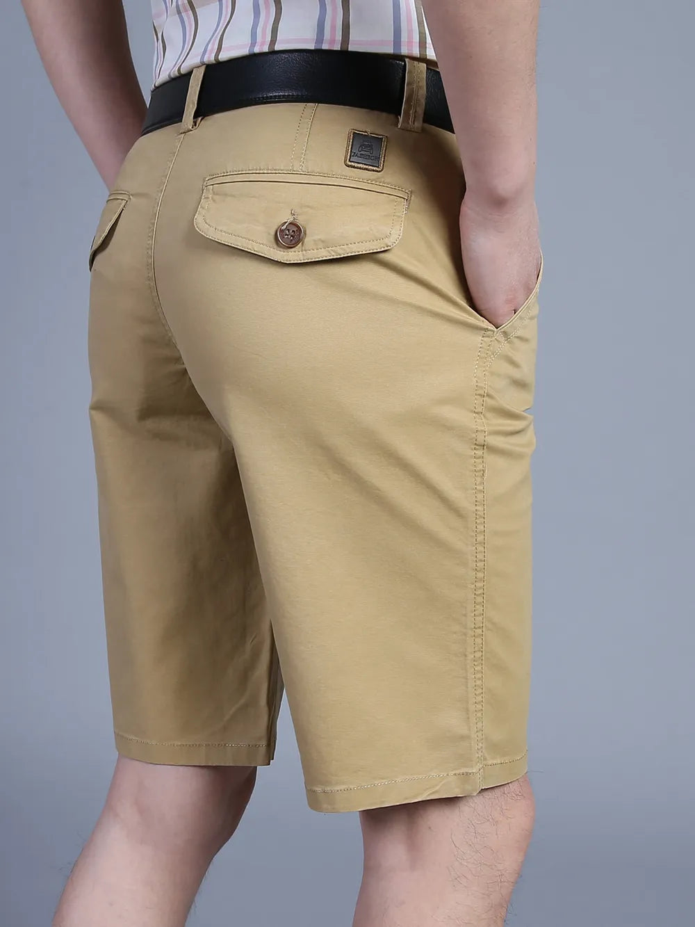 Khaki chino shorts for men with pockets and a button-flap back pocket.
