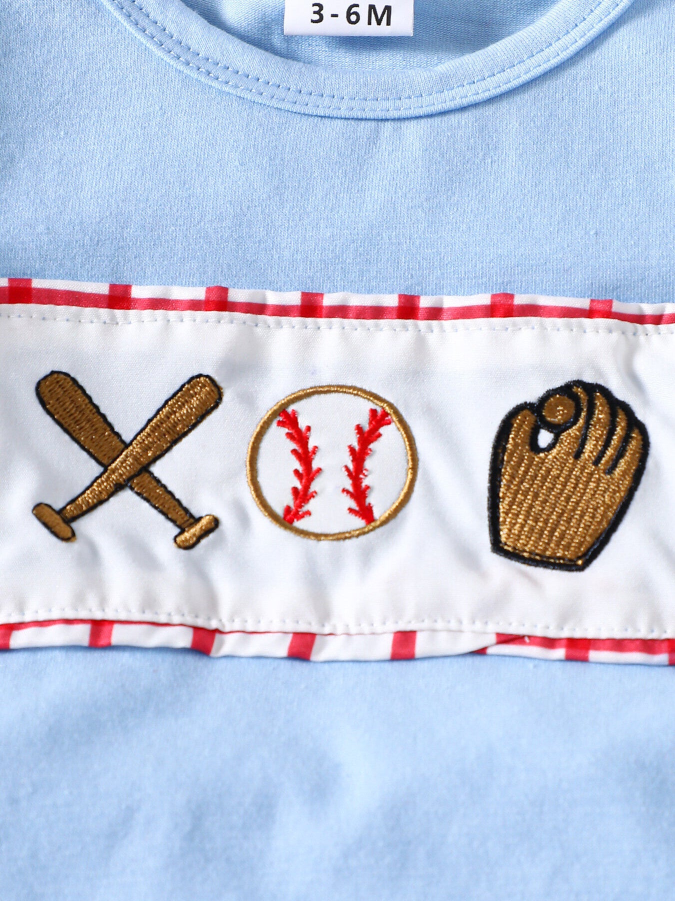 Baby blue cotton top with baseball embroidery and red trim.