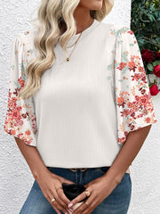 White ribbed half sleeve top with floral print sleeves and a crew neck.