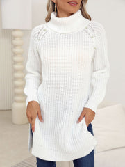 White ribbed knit turtleneck tunic with pearl embellishments on shoulders and sleeves.