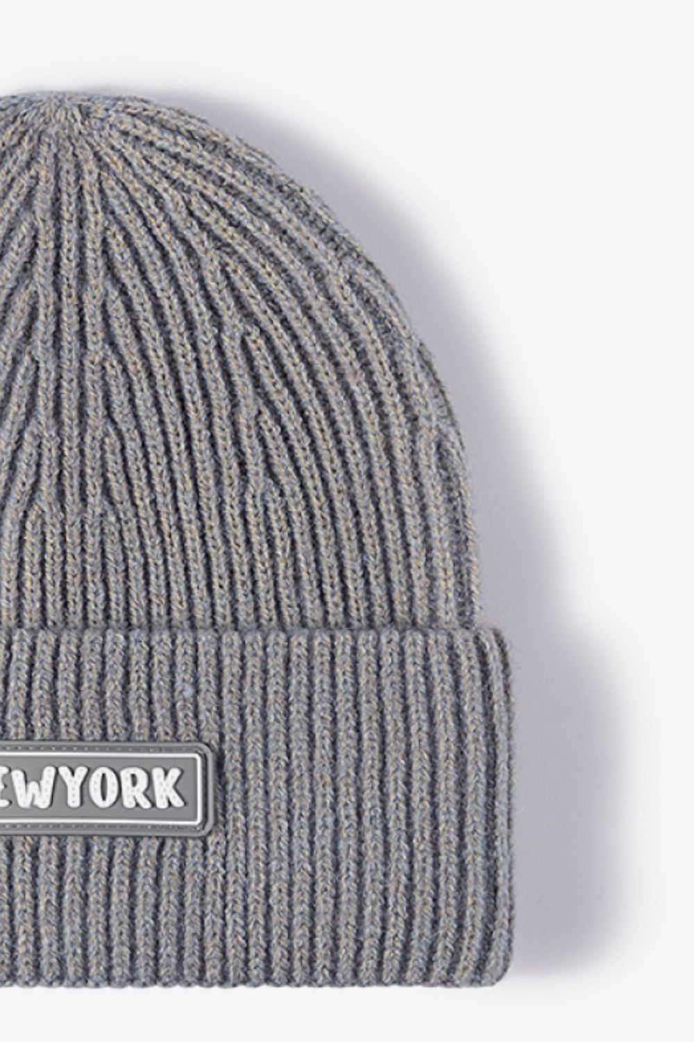 Gray ribbed acrylic beanie with a New York patch detail.